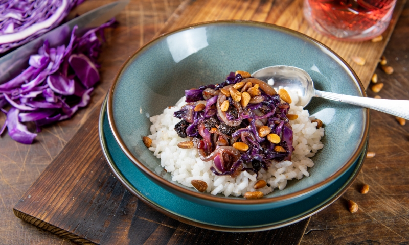 Violetter Spitzkohl mit roten Zwiebeln, Pinienkernen und braunem Reis